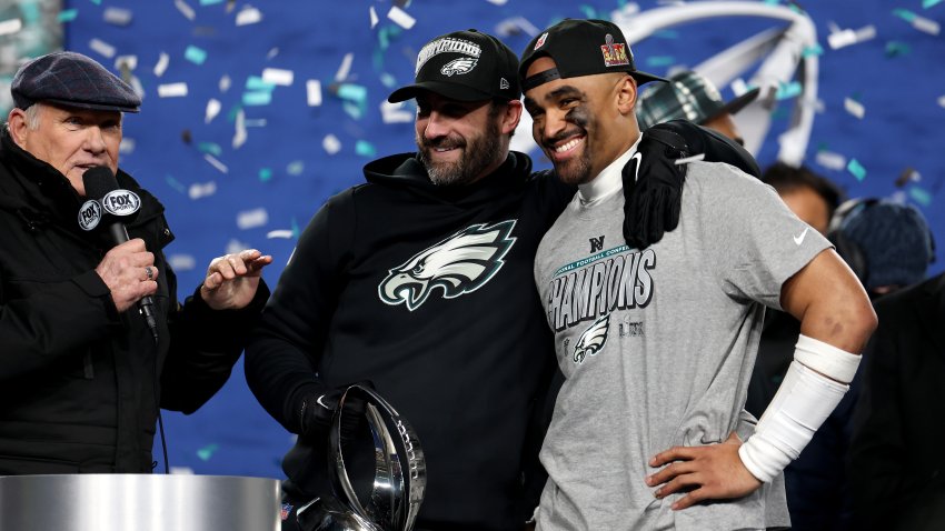 PHILADELPHIA, PENNSYLVANIA – JANUARY 26: Head coach Nick Sirianni and Jalen Hurts #1 of the Philadelphia Eagles smile during the trophy ceremony after defeating the Washington Commanders 55-23 to win the NFC Championship Game at Lincoln Financial Field on January 26, 2025 in Philadelphia, Pennsylvania.  (Photo by Emilee Chinn/Getty Images)