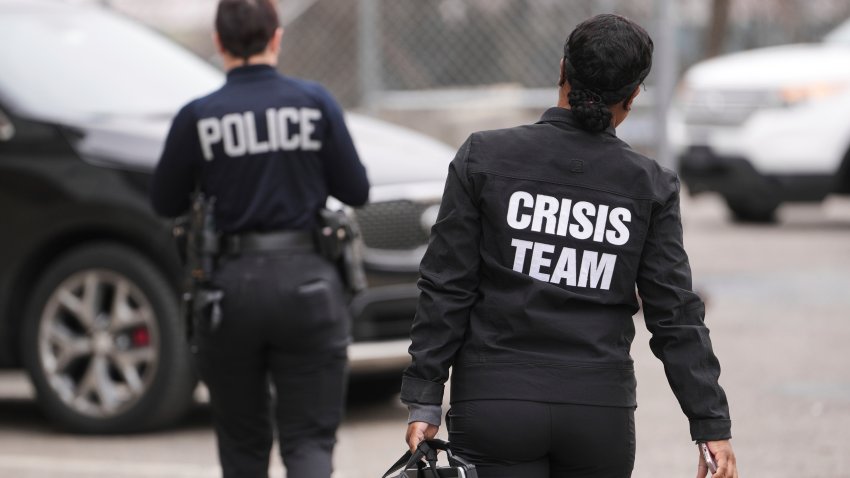 Crisis Intervention Response Team (CIRT) members Therapist Krystian Gardner, right, and Philadelphia Police Officer Vanity Cordero move to their vehicle near the start of their shift in Philadelphia, Friday, March 14, 2025. (AP Photo/Matt Rourke)